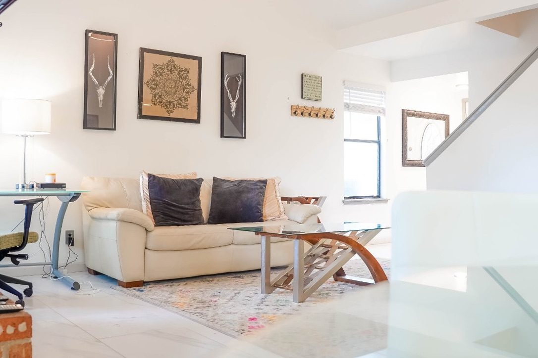 Shared living room with sofa and work desk — Westlake Hills furnished rooms, Austin 78746
