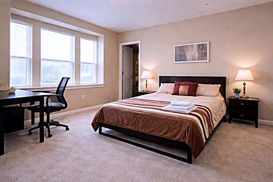 Room 4 furnished bedroom with queen bed, blackout curtains, Smart TV and desk near Samsung Austin