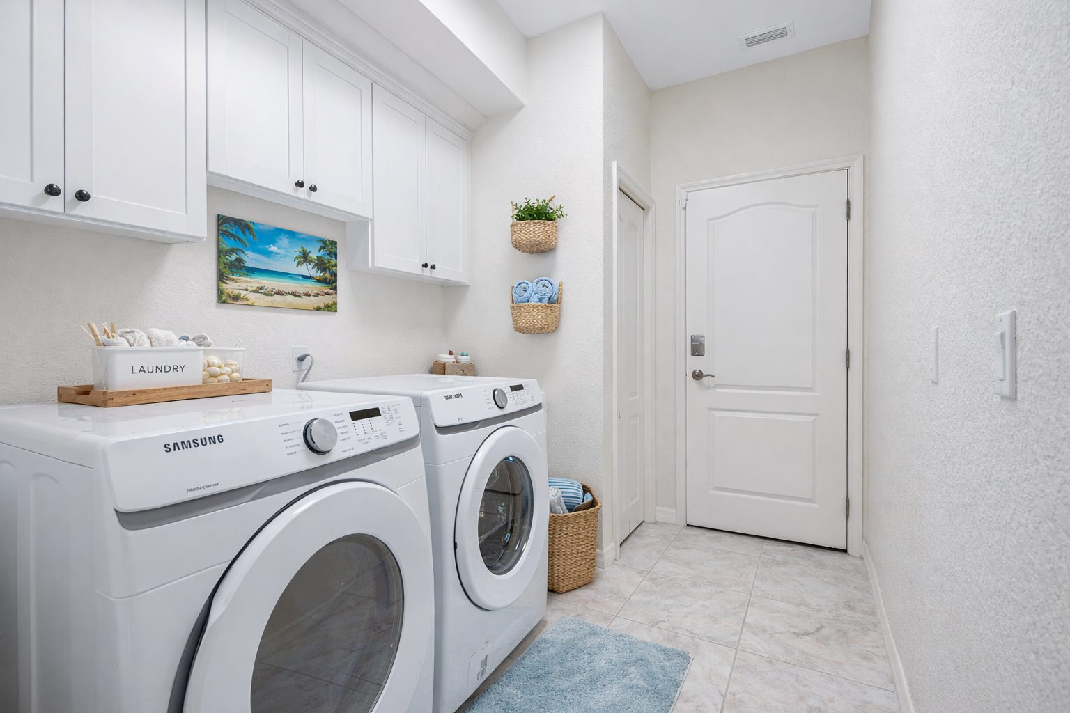 Dedicated laundry room with a washer, dryer and overhead storage.