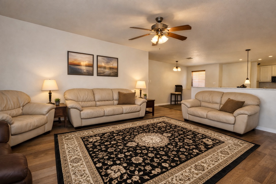 Spacious upstairs lounge and second living room with leather sofas and work-from-home corner in Austin TX shared house