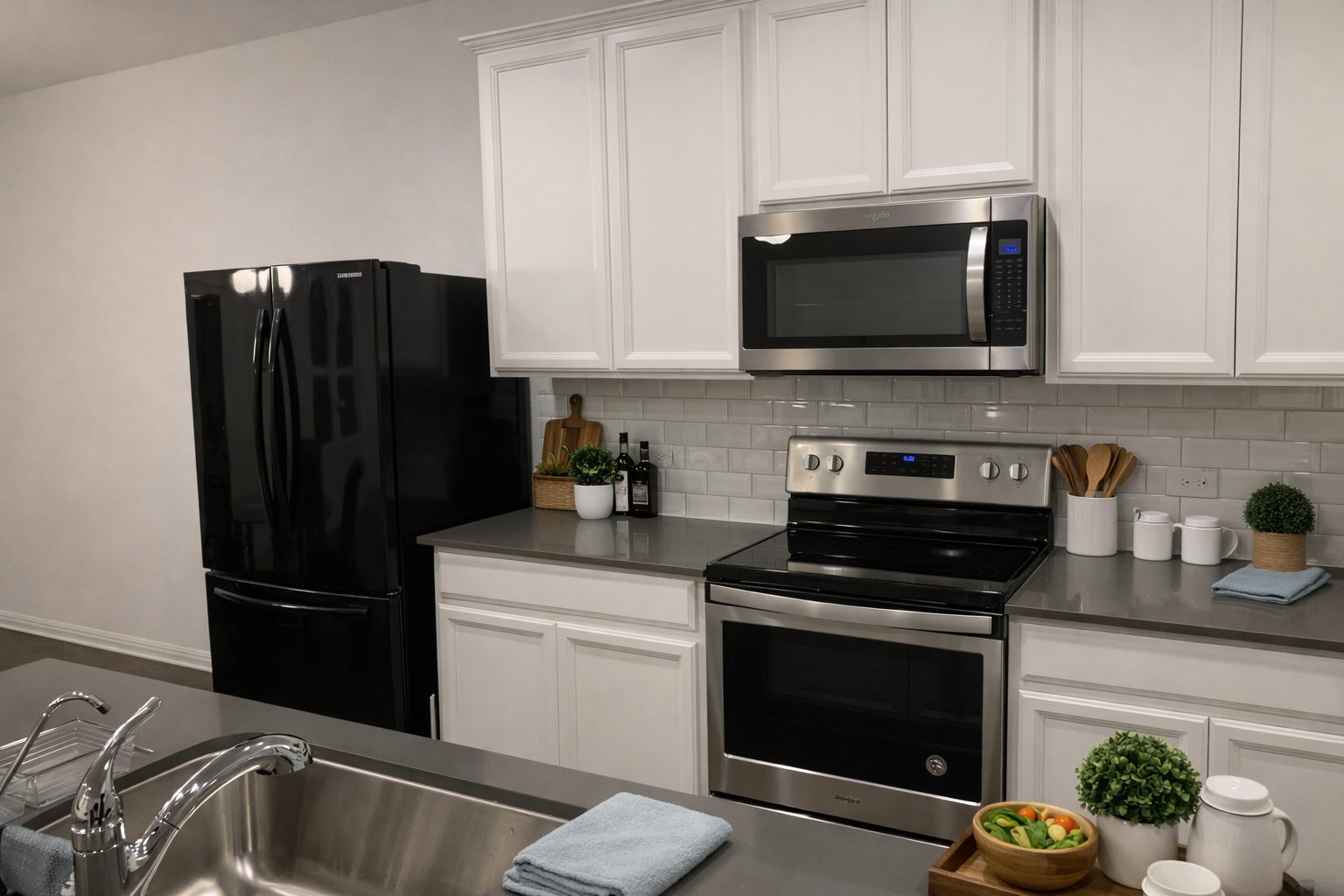 Stainless steel stove, microwave and French-door fridge in corporate housing kitchen Austin