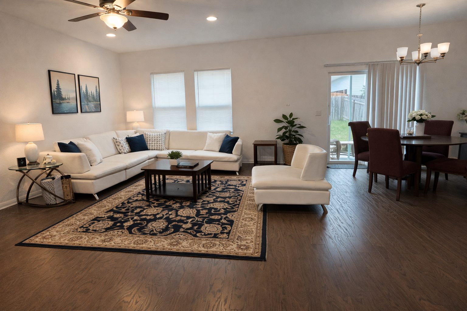 Furnished living room with sectional sofa and dining area at the Parmer East Corporate House, North Austin