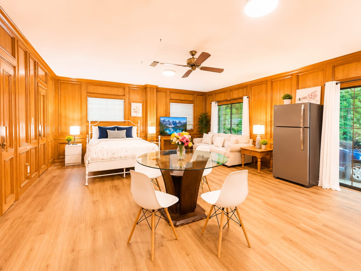 Open-plan furnished studio with queen bed, living area and full-size fridge in Westlake Hills Austin